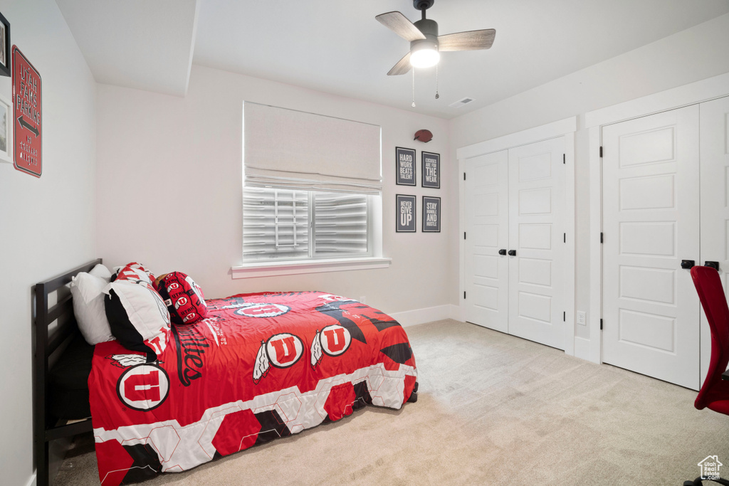 Bedroom featuring baseboards, a closet, a ceiling fan, and carpet floors