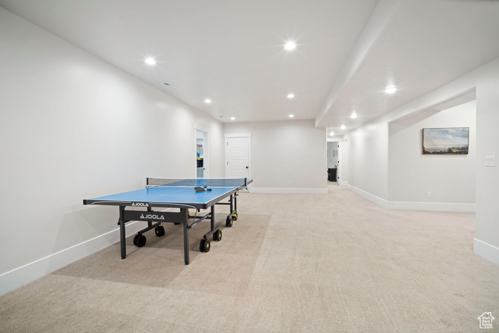 Recreation room featuring light colored carpet, baseboards, and recessed lighting