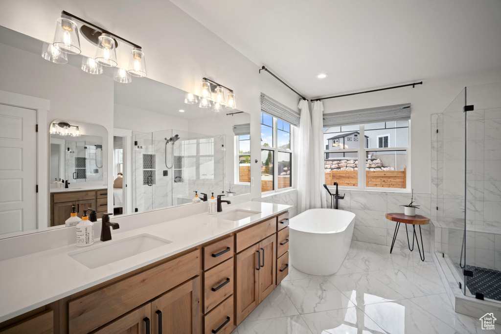 Full bathroom with a sink, double vanity, and a stall shower