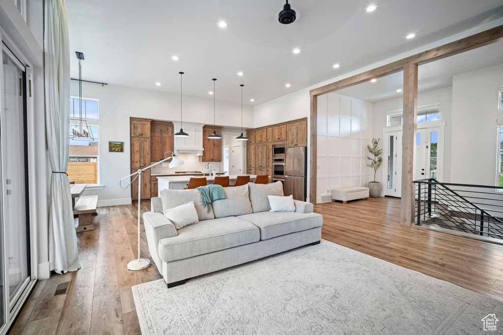 Living area with recessed lighting, plenty of natural light, and wood finished floors