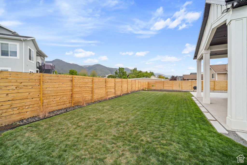 View of yard featuring a fenced backyard, a patio, and a mountain view
