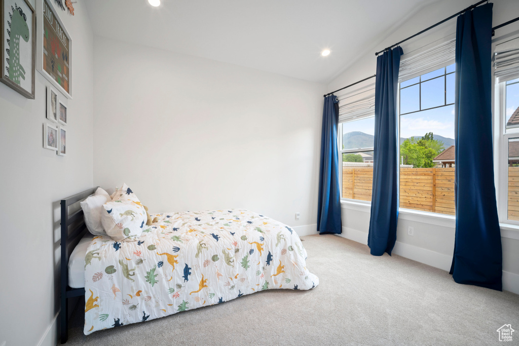 Carpeted bedroom with vaulted ceiling, baseboards, and recessed lighting