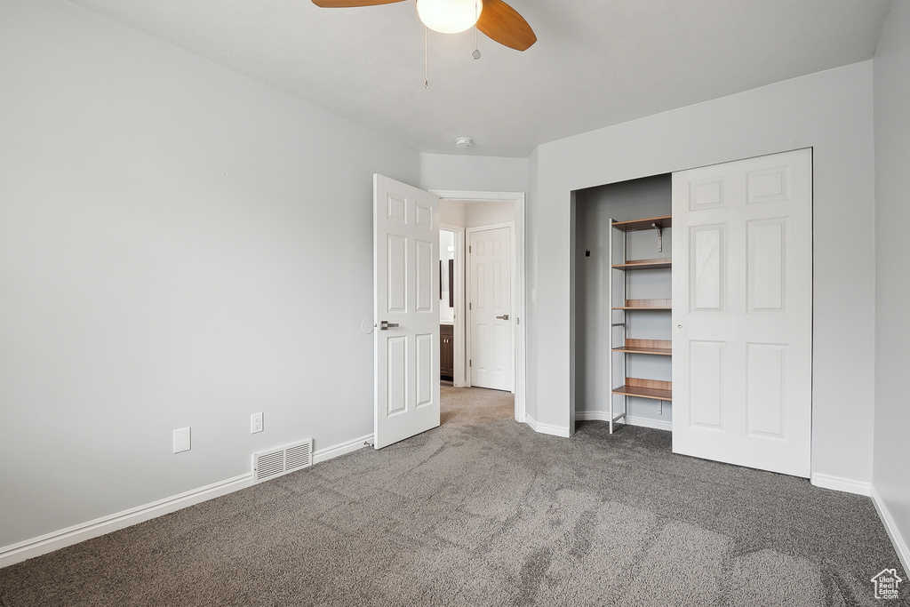 Unfurnished bedroom featuring a closet, baseboards, ceiling fan, visible vents, and carpet floors