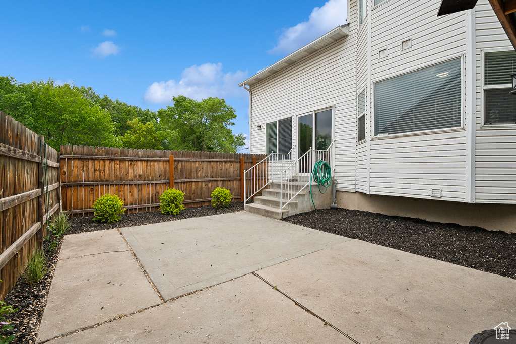 View of patio with a fenced backyard