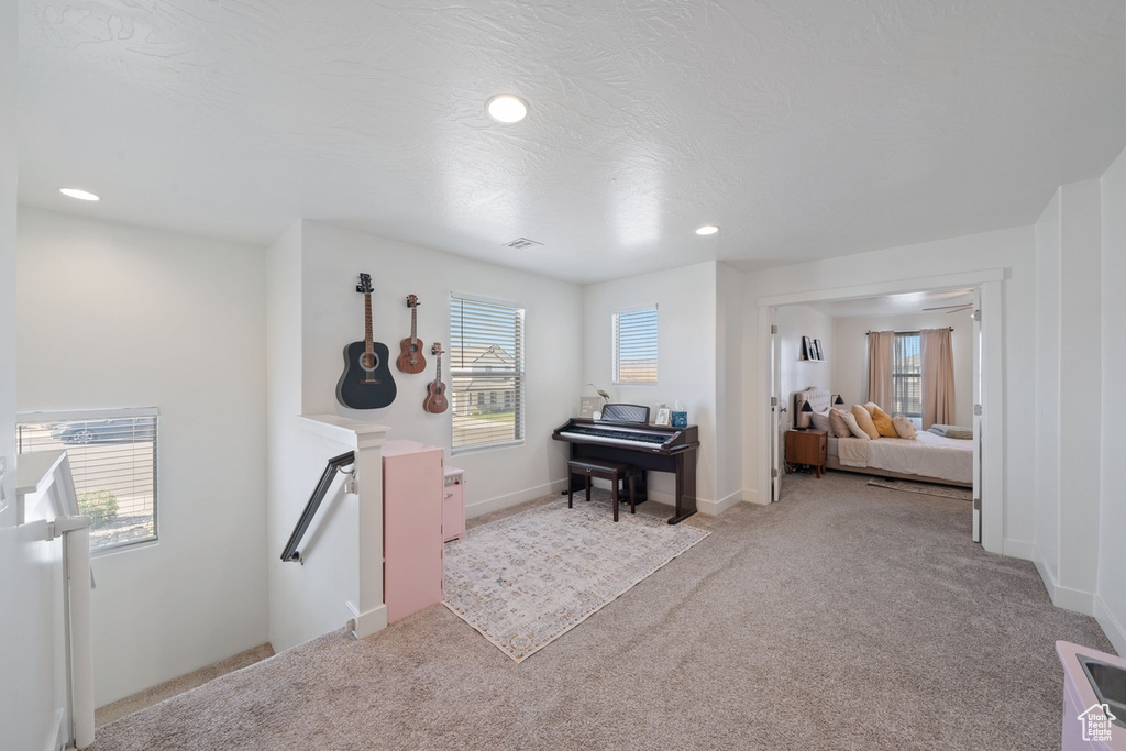 Carpeted bedroom with visible vents and recessed lighting