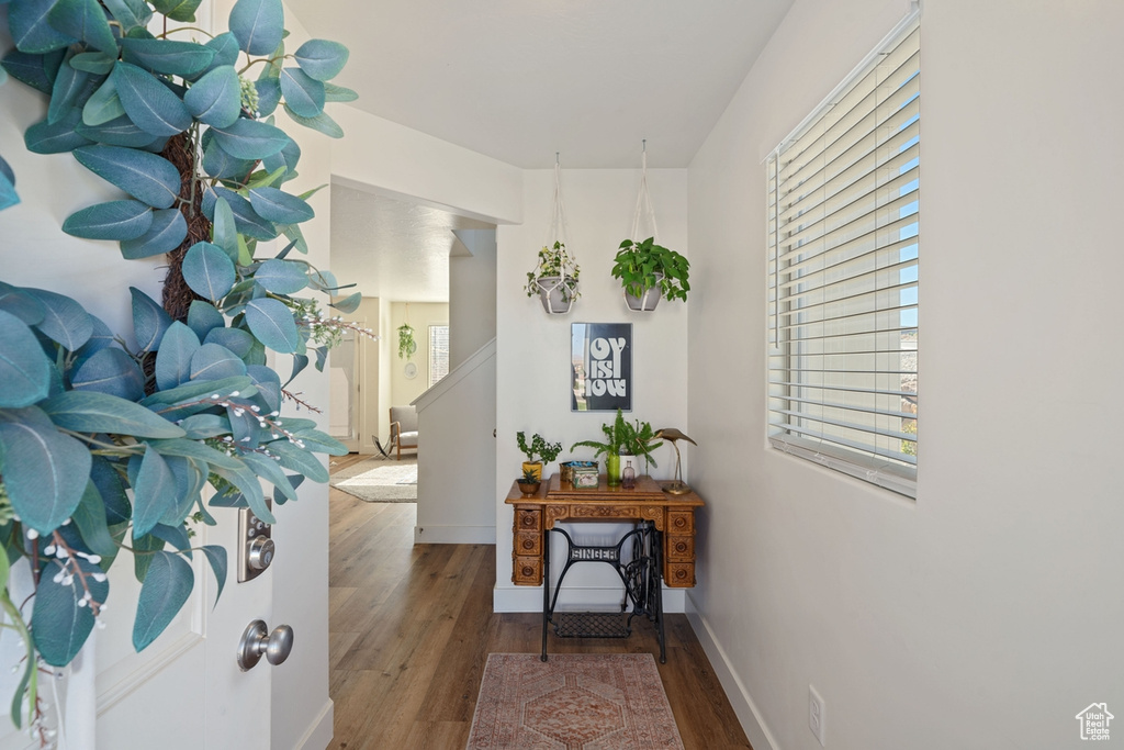 Corridor with baseboards and wood finished floors