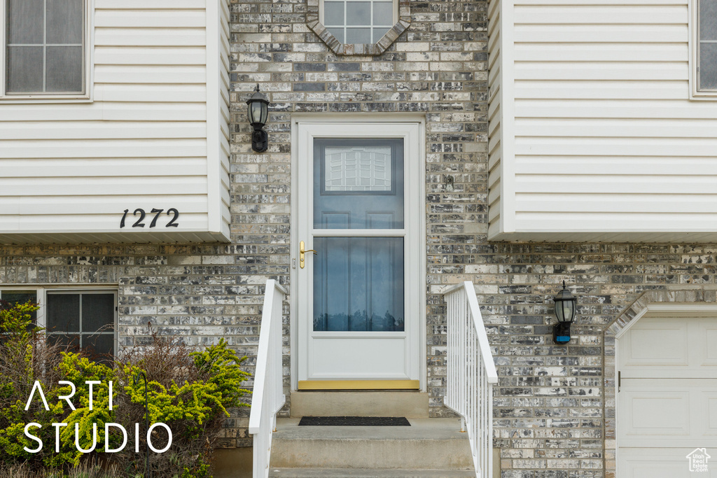 Property entrance featuring brick siding