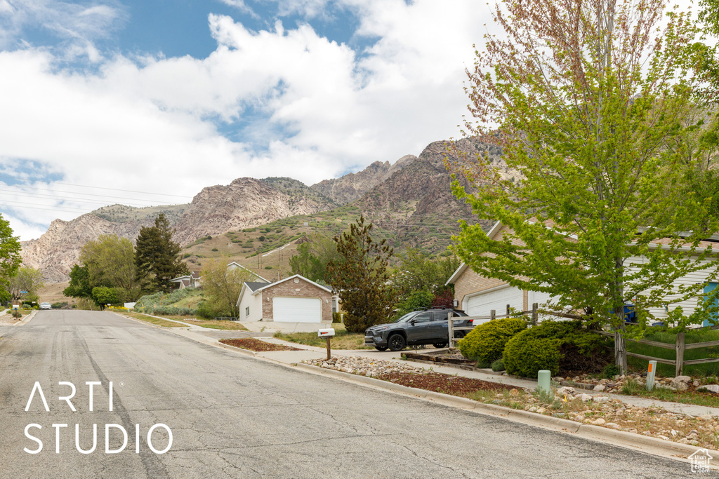 View of asphalt road with a mountain view and curbs
