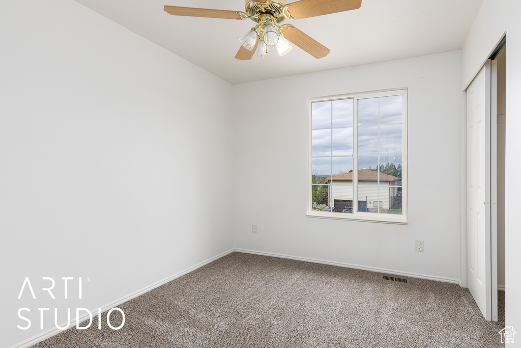 Unfurnished bedroom featuring carpet floors, baseboards, ceiling fan, and a closet