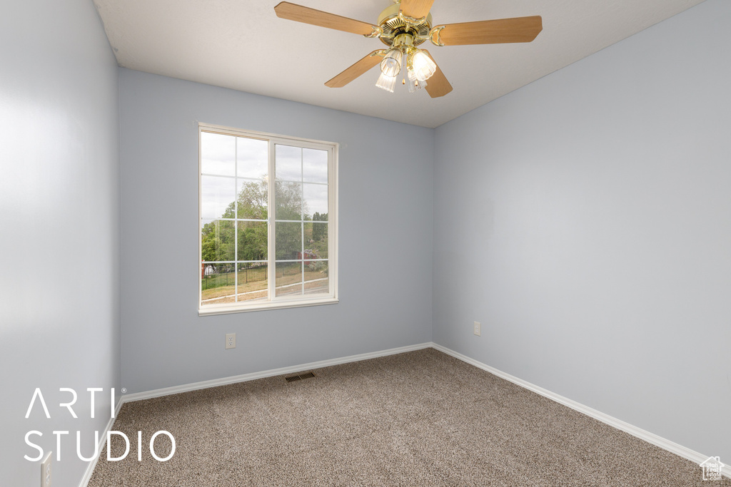 Unfurnished room with carpet flooring, baseboards, and a ceiling fan