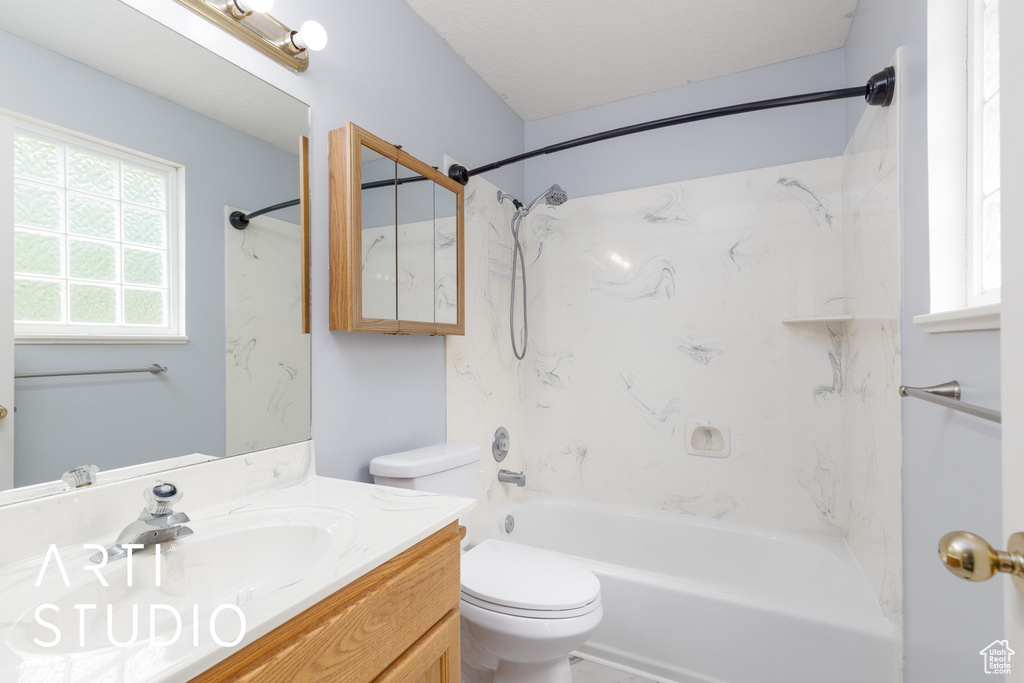Full bath featuring toilet, vanity, and  shower combination