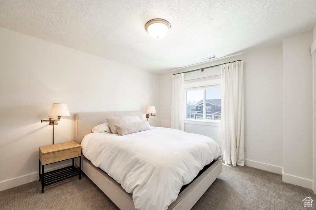 Bedroom with carpet and baseboards