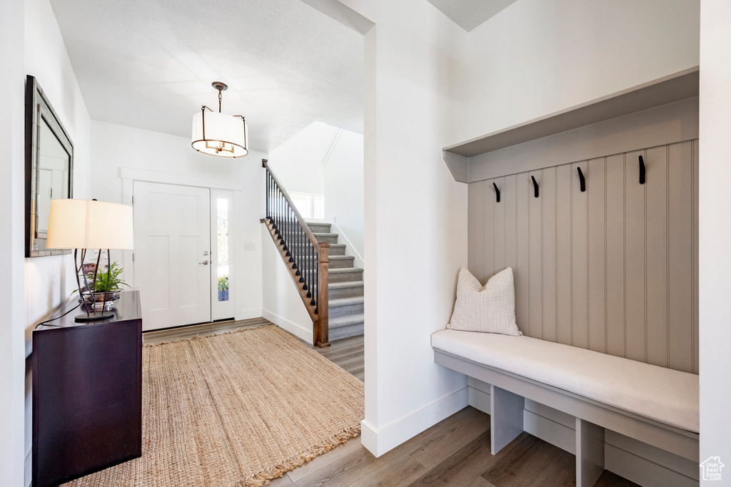 Mudroom with wood finished floors and baseboards