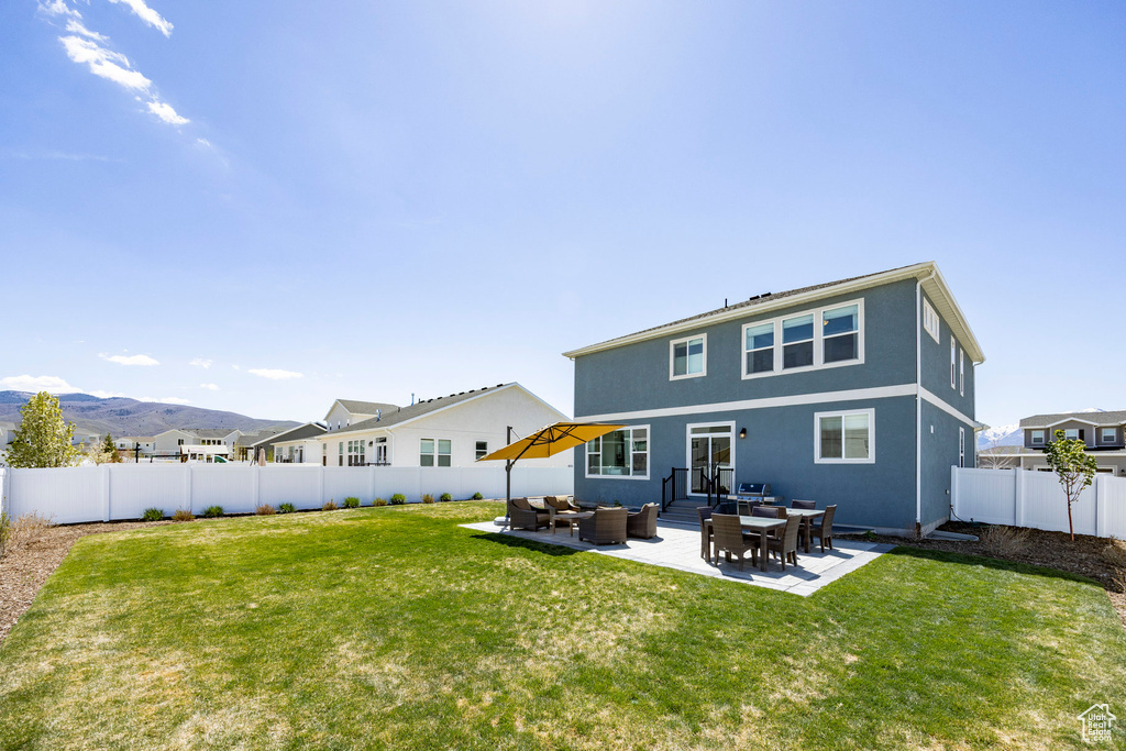 Rear view of house featuring an outdoor hangout area, a patio, and stucco siding
