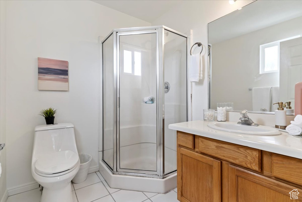 Full bathroom with tile patterned flooring, a shower stall, vanity, and toilet