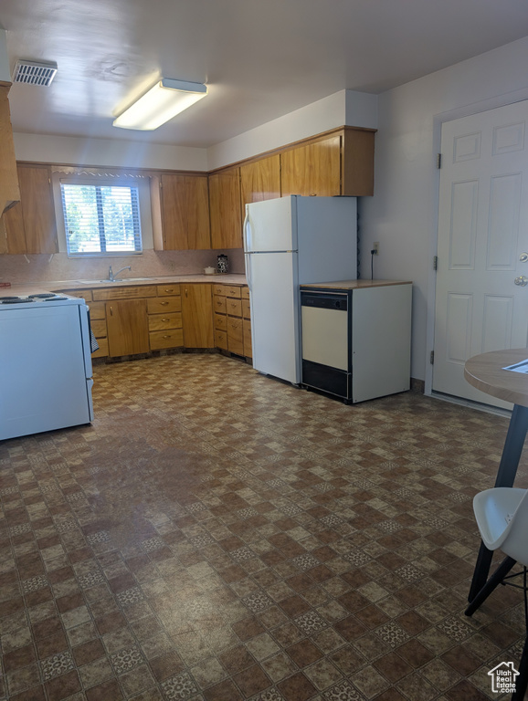 Kitchen with white appliances and light countertops