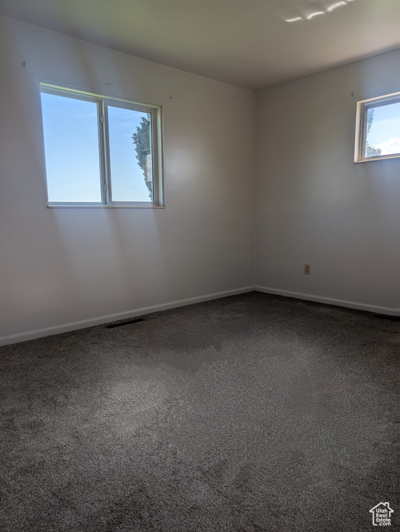 Carpeted spare room with baseboards