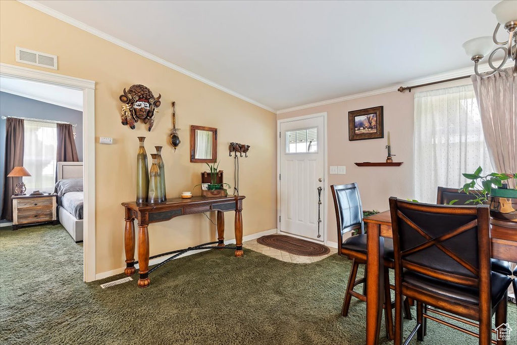 Entrance foyer featuring ornamental molding, carpet, baseboards, and visible vents