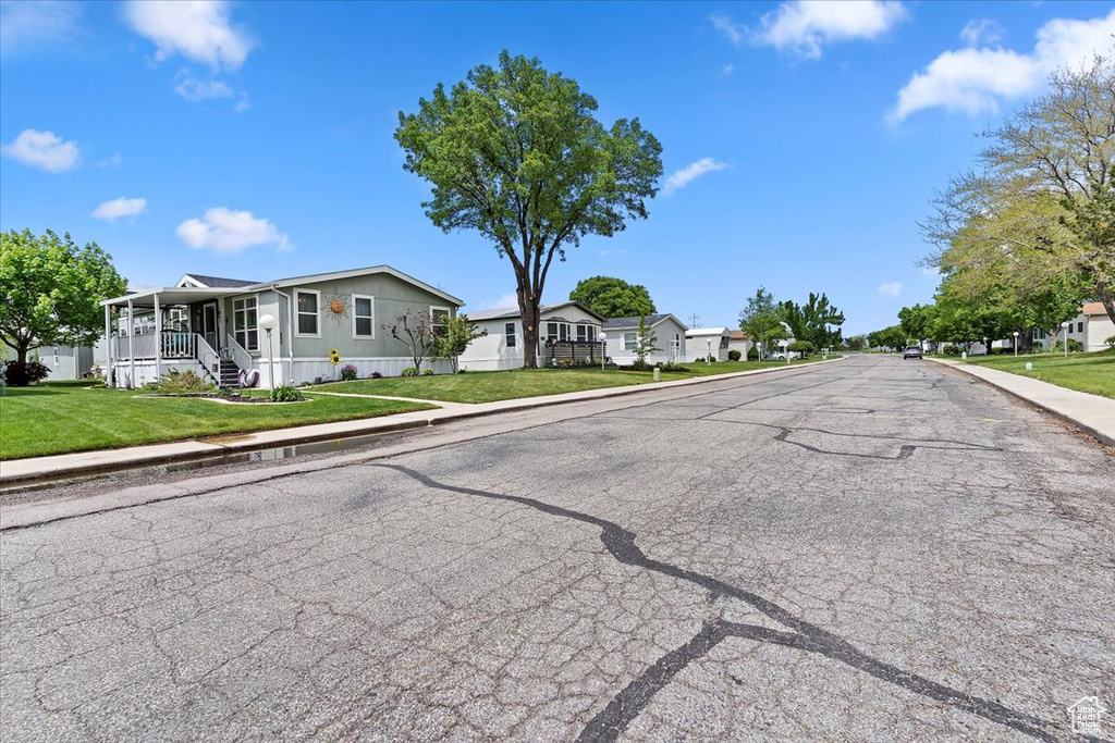 View of street featuring curbs, sidewalks, and a residential view