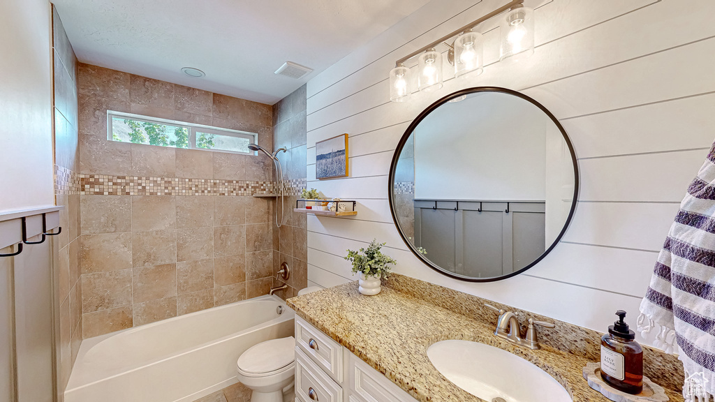 Full bath featuring vanity, toilet, and bathing tub / shower combination