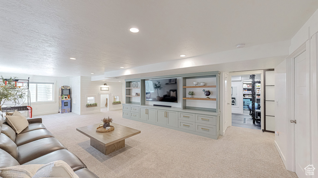 Living room featuring light colored carpet, baseboards, and recessed lighting