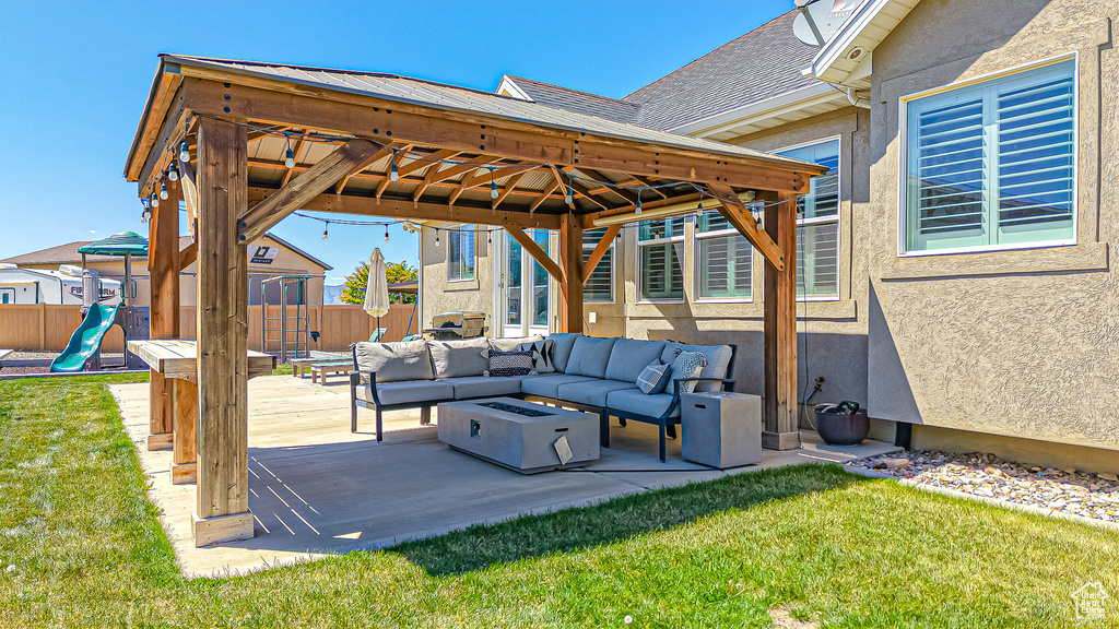 View of patio with outdoor lounge area, a gazebo, and a playground