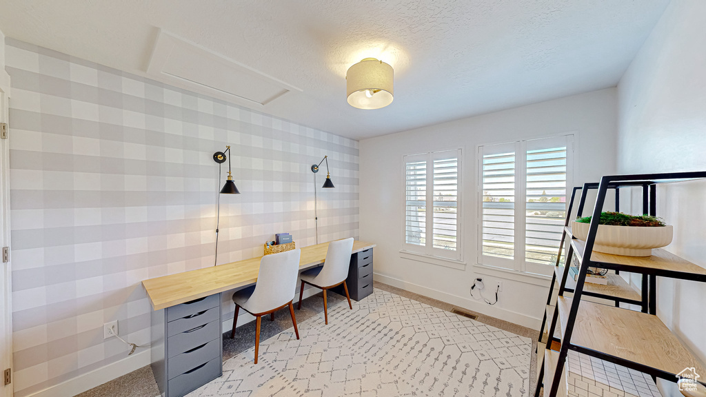 Office space with baseboards, attic access, and a textured ceiling