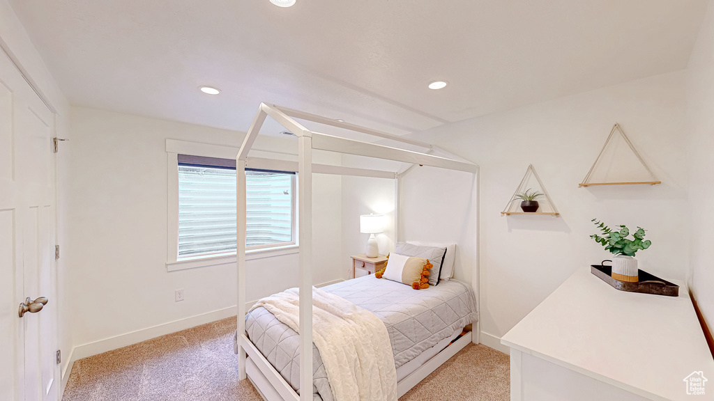 Bedroom featuring light carpet, recessed lighting, and baseboards