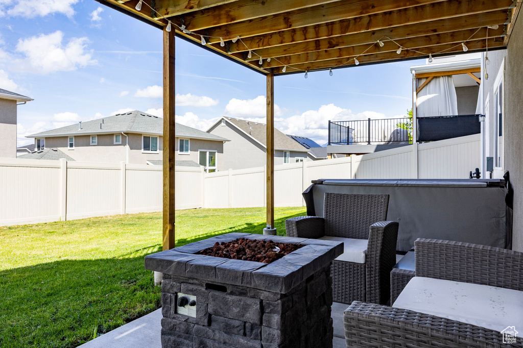 View of patio featuring an outdoor fire pit and a residential view