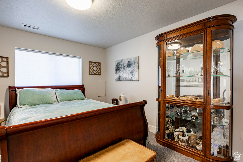 Bedroom featuring carpet and baseboards