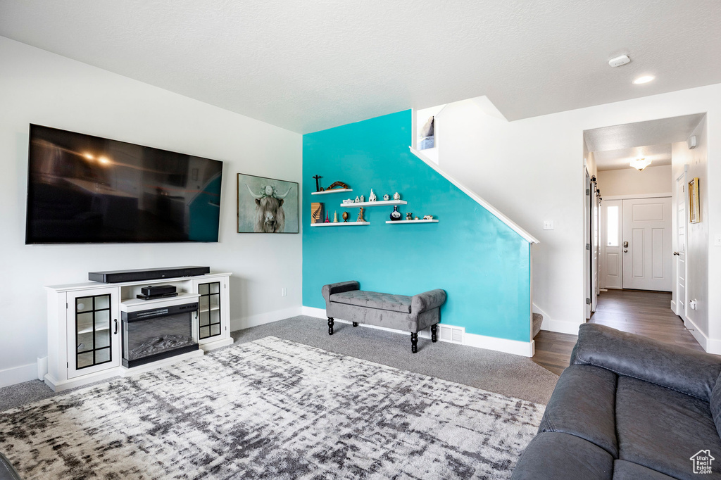 Living room with baseboards and stairway