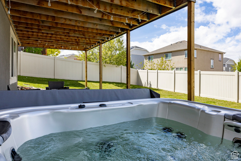 View of pool with a hot tub