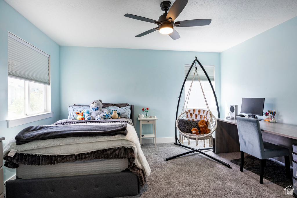 Bedroom with carpet flooring, an office area, and ceiling fan