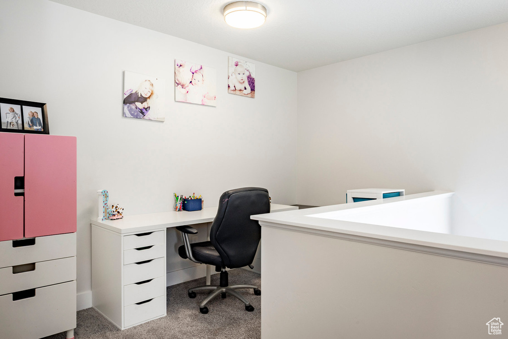 Office space with light carpet and baseboards