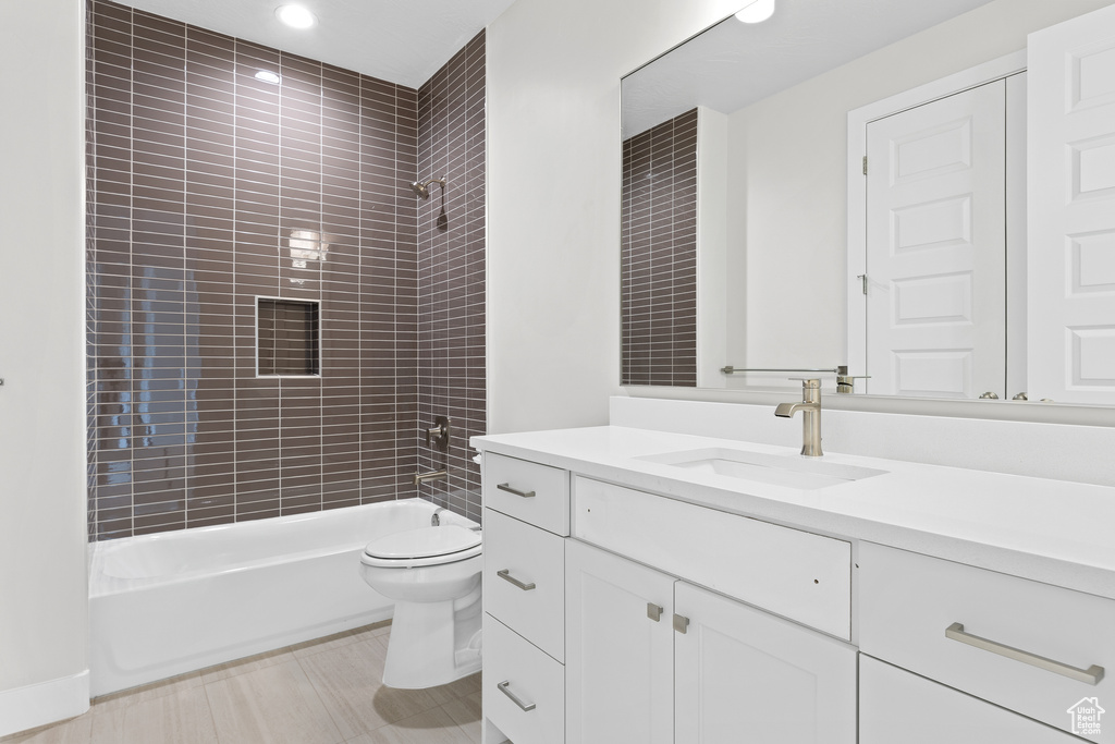 Full bath featuring toilet,  shower combination, and vanity