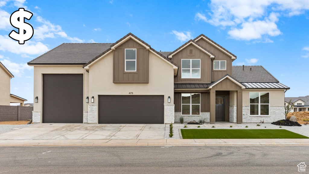 View of front of home featuring a standing seam roof, stone siding, concrete driveway, a metal roof, and a garage