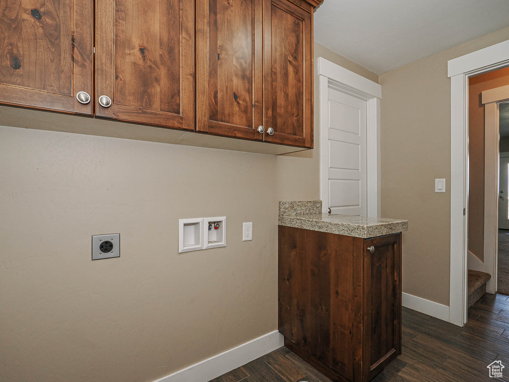 Laundry area featuring electric dryer hookup, dark wood-style flooring, baseboards, washer hookup, and cabinet space