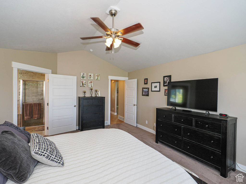 Bedroom featuring lofted ceiling, baseboards, carpet flooring, a ceiling fan, and ensuite bathroom