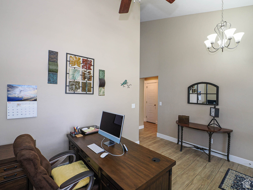Office featuring a ceiling fan, light wood-type flooring, a chandelier, and baseboards