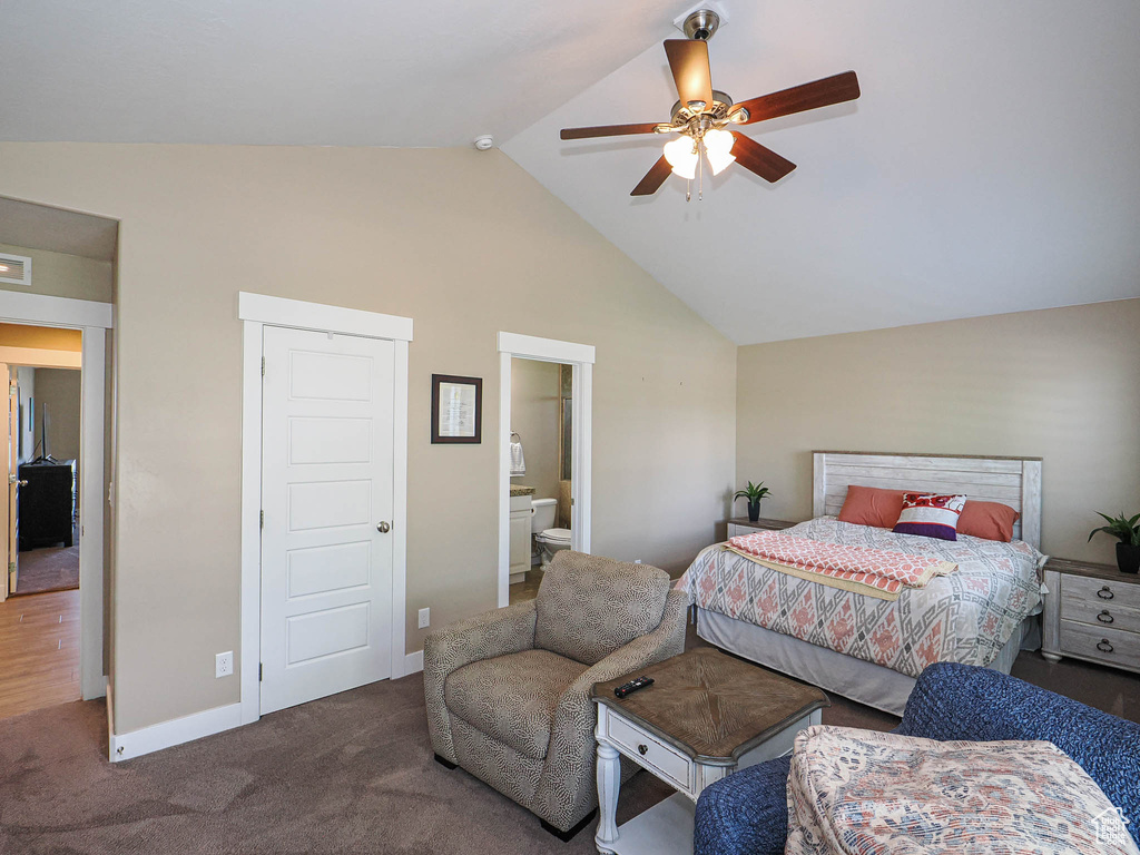Carpeted bedroom featuring high vaulted ceiling, baseboards, ensuite bath, and a ceiling fan
