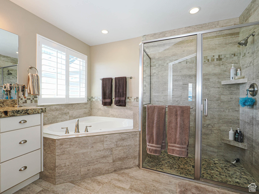 Full bathroom with a garden tub, a shower stall, vanity, and recessed lighting