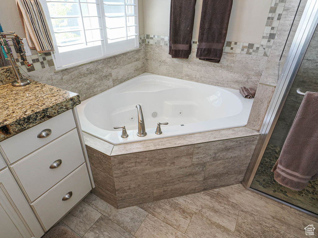Bathroom featuring a whirlpool tub and vanity