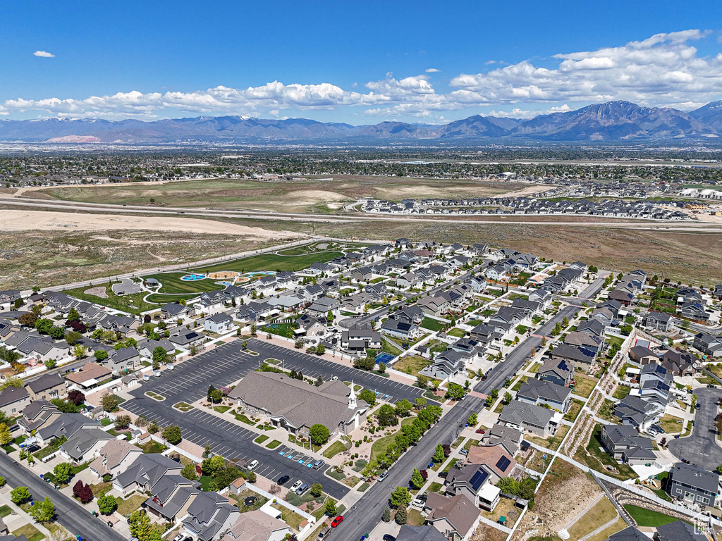Aerial overview of property\\\'s location with a mountainous background and nearby suburban area