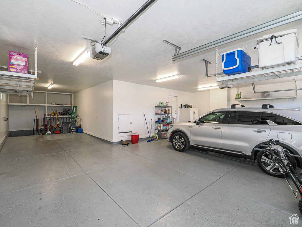 Garage with a garage door opener and baseboards