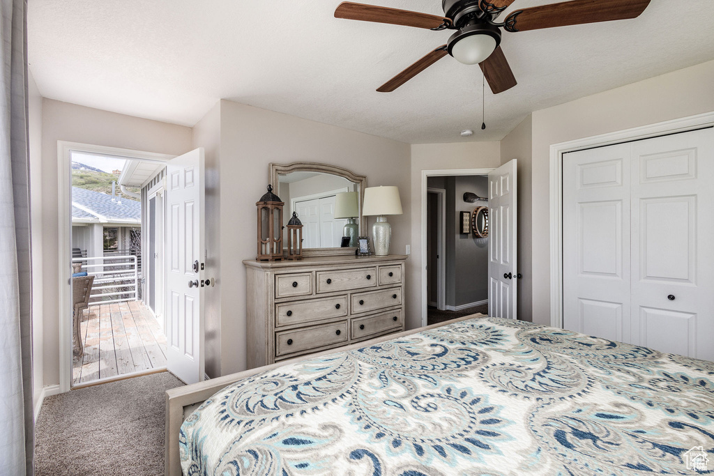 Carpeted bedroom featuring a closet and a ceiling fan
