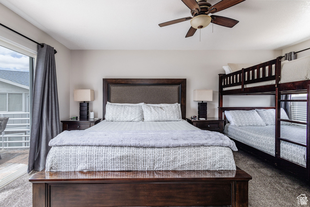 Carpeted bedroom featuring multiple windows and a ceiling fan