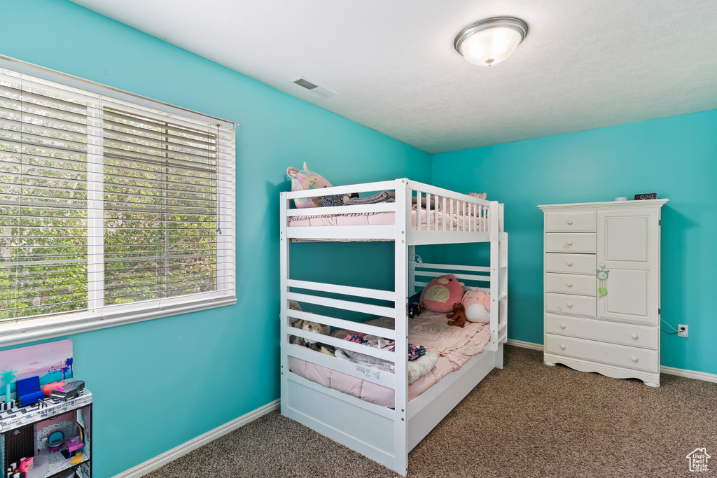 Carpeted bedroom featuring baseboards