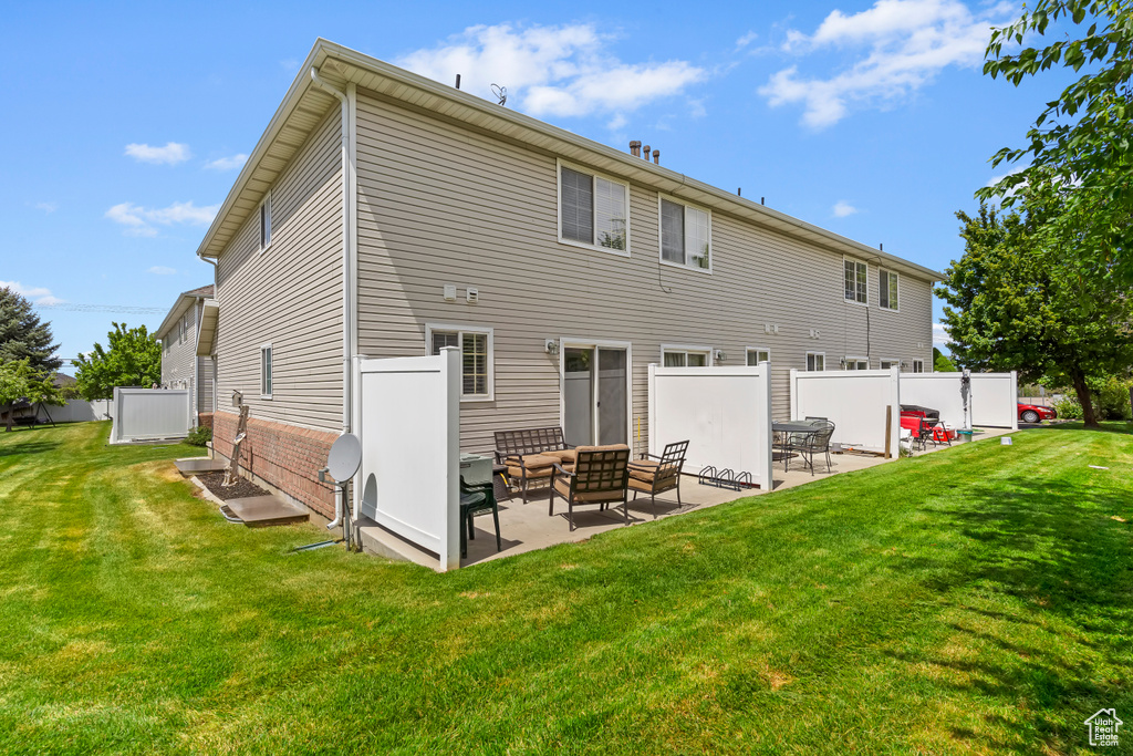 Rear view of property with a patio, outdoor lounge area, and brick siding