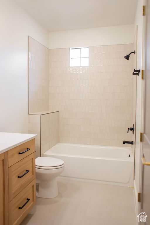 Bathroom with toilet, vanity, and washtub / shower combination