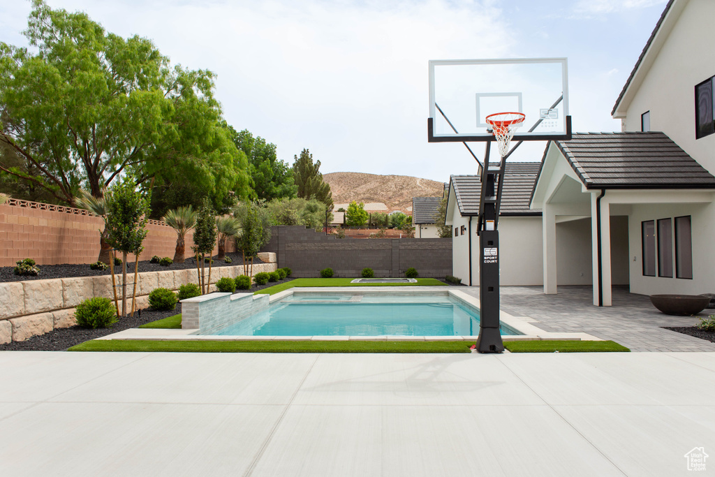View of pool with a mountain view, a fenced in pool, and a fenced backyard
